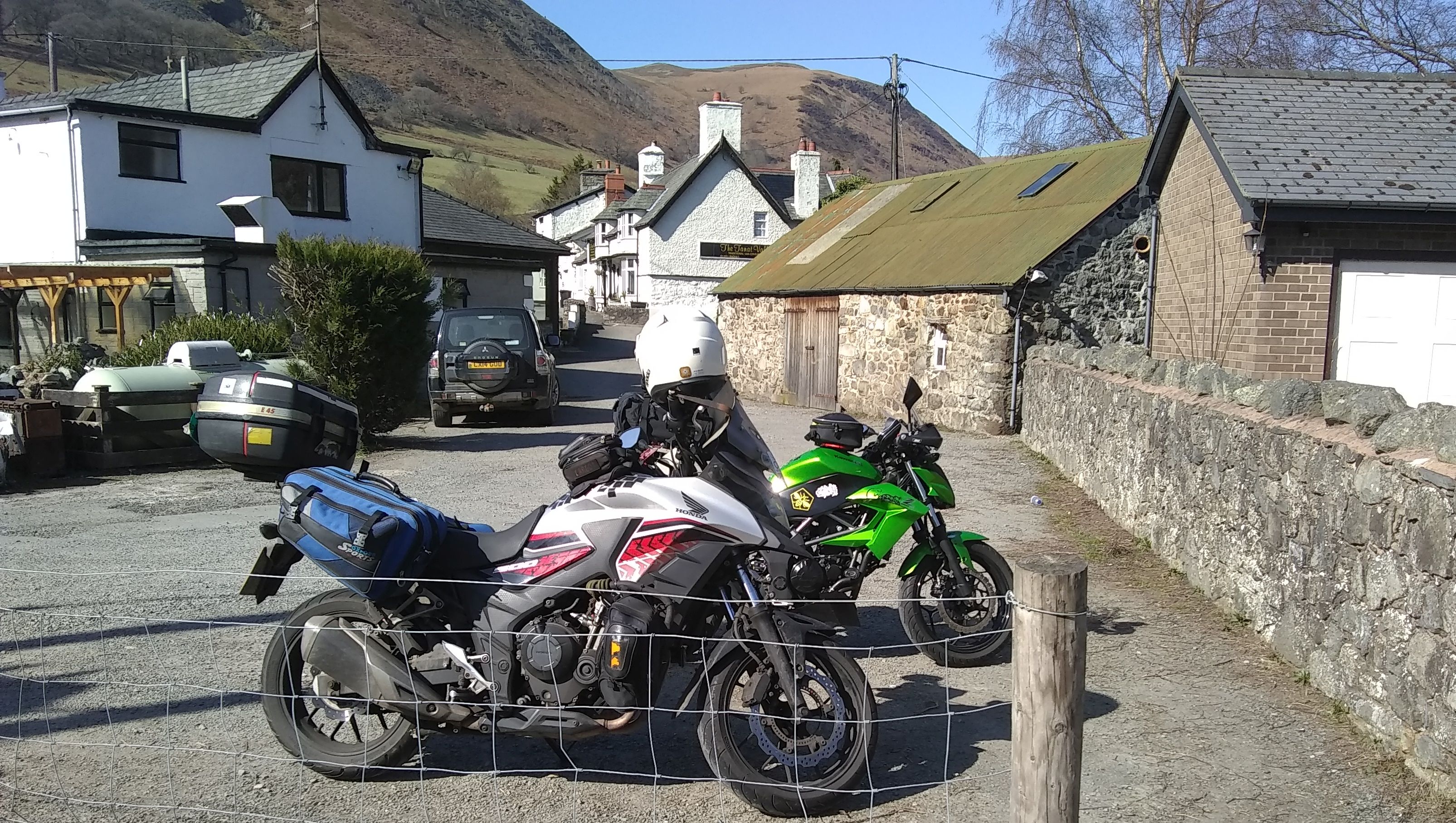 2 motorcycles with luggage with stunning Welsh mountains in the background